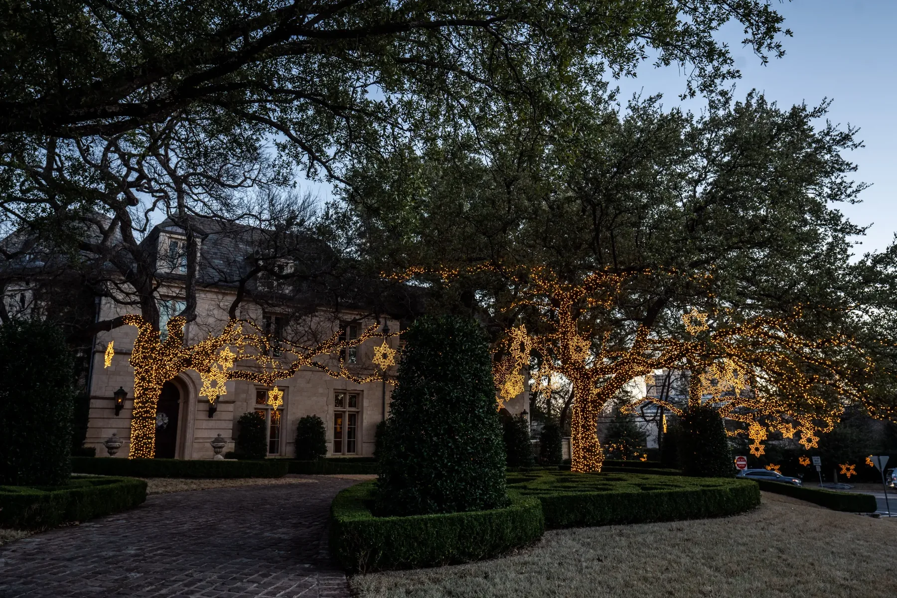 Corpus Christi estate holiday lighting with illuminated mature trees